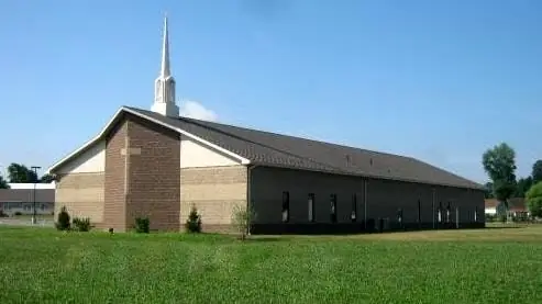 A brick church with a white steeple, one of L & M's church projects